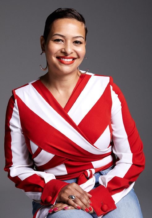 Portrait of Stephanie Roberson smiling, in a red and white striped wrap top